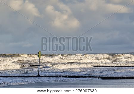 Storm At Sea - Blackboard With Danger Warning And Waves Attack The Sea Coast