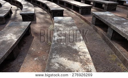 cement benches on a bosky open auditorium