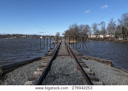 Railroad Tracks Cross Manalapan Lake In Thompson Park In Middlesex County New Jersey.
