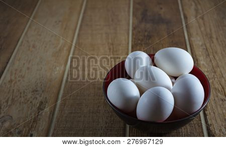 Close Up White Chicken Eggs, Inside A Bowl, On A Wooden Table.