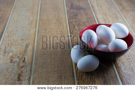 Close Up White Chicken Eggs, Inside A Bowl, On A Wooden Table.