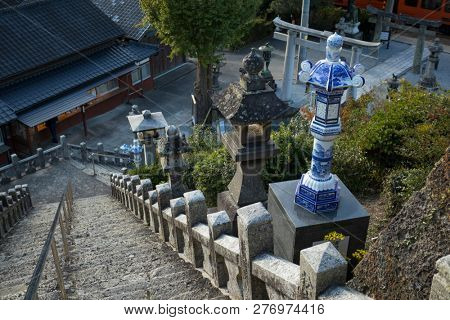 Arita, Japan - October 30, 2018:  Blue and white lanterns near the stairs of the Tozan shrine in Arita at dusk 