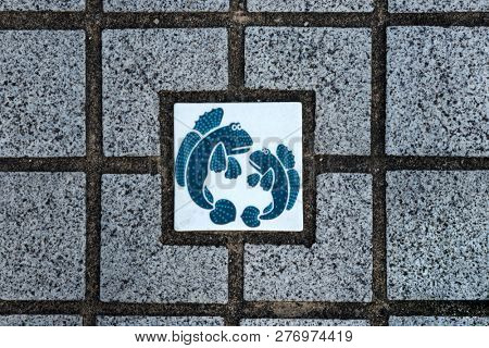 Arita, Japan - October 30, 2018: Arita blue and white porcelain tile with fishes  as a decoration in the wall