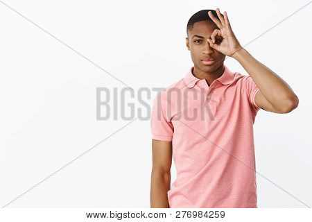 I Watching You. Charismatic Serious-looking Handsome Young African American Male Showing Okay Gestur