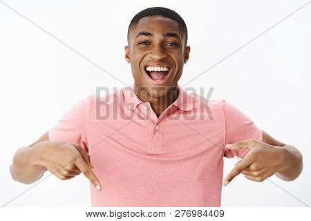 Excited And Impressed Happy African American Man Standing High Pointing Down With Amazed And Cheerfu