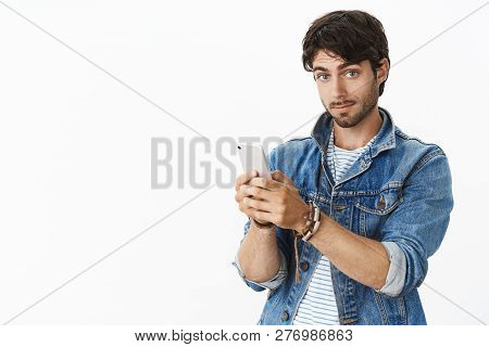 Not Bad I Like This Gadget. Portrait Of Impressed Good-looking European Male With Bristle And Blue E