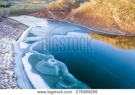 partially frozen mountain lake in northern Colorado foothills - Horsetooth Reservoir