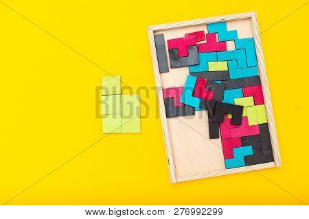Wooden Multicolored Puzzle On Yellow Background. Flat Lay