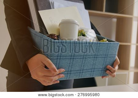 Business Woman Moving Offices Packing Up Cardboard Box In Office.