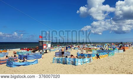 Wladyslawowo, Poland - July 12, 2020: People Are Resting On The Beach On A Sunny Day In Wladyslawowo