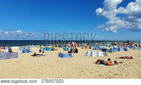 Wladyslawowo, Poland - July 12, 2020: People Are Resting On The Beach On A Sunny Day In Wladyslawowo