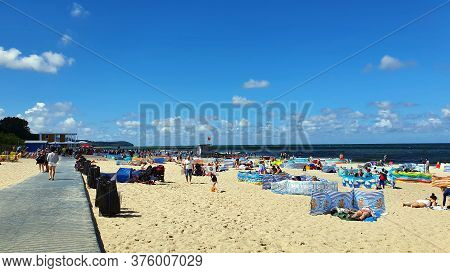Wladyslawowo, Poland - July 12, 2020: People Are Resting On The Beach On A Sunny Day In Wladyslawowo