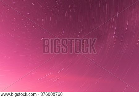 Background Of Round Or Circular Star Track Or Trajectory On The Red, Pink Or Rose Clear Night Sky. S