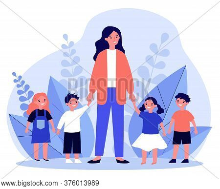 Kindergarten Teacher Walking With Kids. Positive Young Woman Leading Happy Kids By Hands Outdoors. I