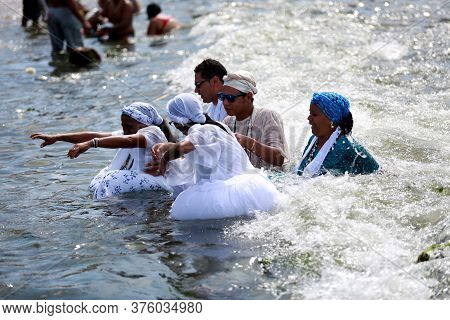Salvador, Bahia / Brazil - February 2, 2015: Supporters Of Candomble Are Seen On The Rio Vermelho Be
