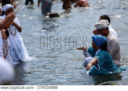 Salvador, Bahia / Brazil - February 2, 2015: Supporters Of Candomble Are Seen On The Rio Vermelho Be