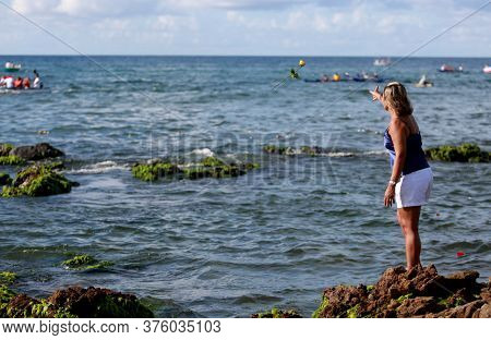 Salvador, Bahia / Brazil - February 2, 2015: Supporters Of Candomble Are Seen On The Rio Vermelho Be