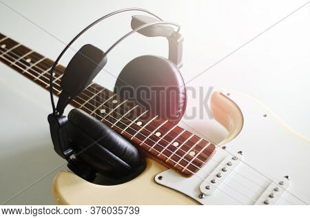 Electric Guitar , Macro Abstract And Headphones, Used To Play Music And Notes.
