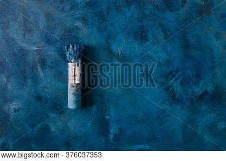 Brush On Top Of Finished Work Of An Abstract Textured Painting Or Photography Backdrop With Blue And