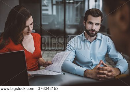 Man And Woman Reading An Oficial Paper