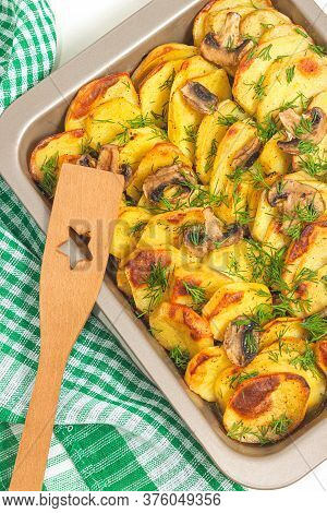 Potato Wedges Baked With Mushrooms, Herb Oven Roasted, With Thyme, A Close-up In A Baking Tray. Top 