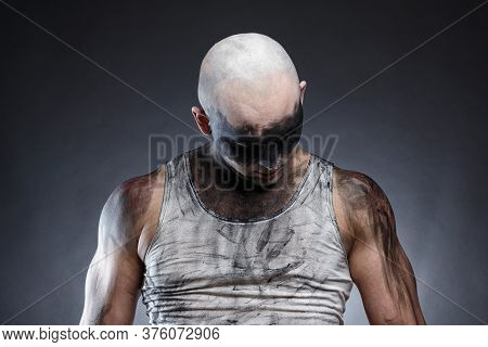 Photo Of Bald Dirty Man With Head Down On Gray Background
