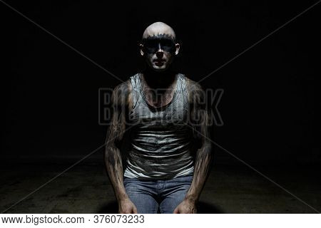 Bald Dirty Man Sitting On His Laps