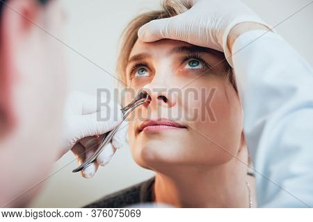 Otolaryngologist Examines Womans Nose With Nasal Dilator.