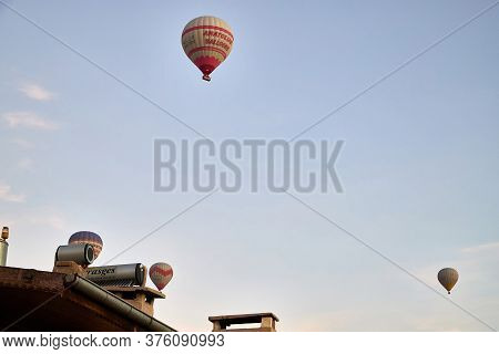 Cappadocia, Turkey - December 20, 2019: Hot Air Balloons Flying In Blue Sky With White Clouds Over H
