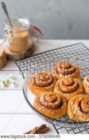 Freshly Baked Cinnamon Buns With On A Wooden Background. Kanelbule - Swedish Dessert. Food Concept. 
