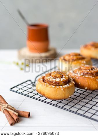 Freshly Baked Cinnamon Buns With On A Wooden Background. Kanelbule - Swedish Dessert. Food Concept. 