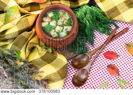 Chicken Autumn Broth With Croutons And Greens On The Background Of A Yellow Checkered Scarf And Fall
