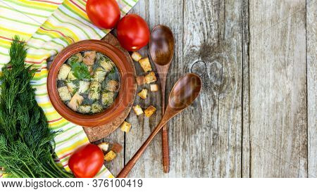 Autumn Transparent Broth With Croutons And Dill In A Clay Pot With Tomatoes Lying Next To It, A Bunc