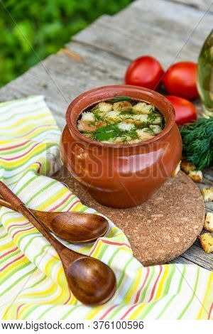 Delicious Broth With Croutons, Dill, Tomatoes In The Fresh Air. Lunch With Soup In A Clay Pot Vegeta