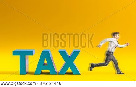 businessman escapes from the taxes inscription. unsustainable tax burden concept.