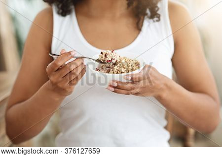 Healthy Diet. Unrecognizable African Woman Eating Oatmeal With Fruits For Breakfast, Cropped Imgae, 