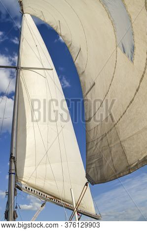 Mast With Sails Against The Blue Sky