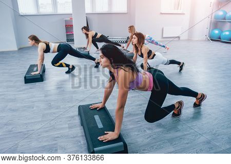 Young Fitness Women Using Step Platform At The Gym. Crossfit Training.