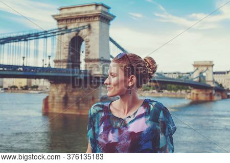 Young Redhead Woman Posing At Chain Bridge, Lanchid, Budapest, Hungary