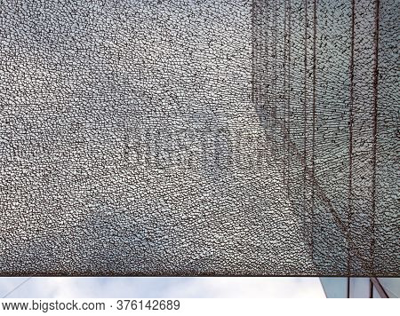 A Pane Of Shattered Glass In Front Of A Modern Office Building With Straight Edge Dividing The Image