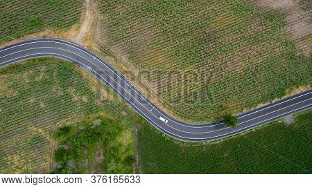 Aerial View Road Curve Construction. Aerial Above View Of A Rural Landscape With A Curvy Road Runnin