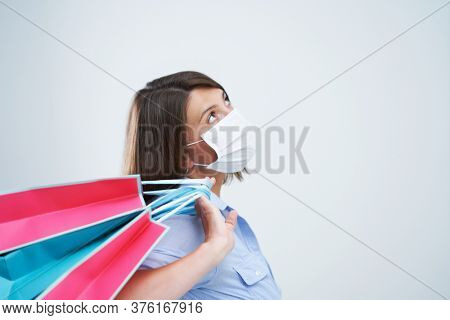 Attractive woman wearing protective mask isolated over white background