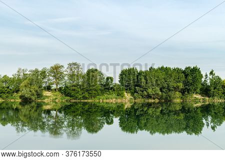 Reflection Of Green Trees In Water Surface Of Lake Called Zelena Voda In Slovakia.