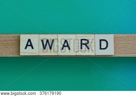 Gray Word Award Made Of Wooden Square Letters On Green Background