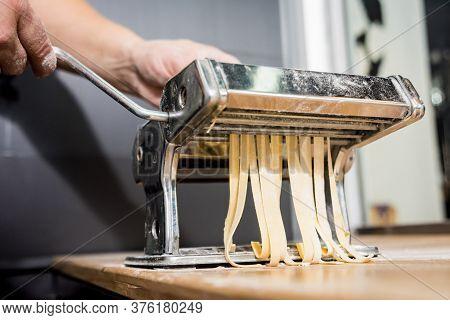 Chef Rolling Dough With A Pasta Machine. Pasta Maker Machine. Hom