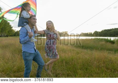 The Family Launches Kite Against Beautiful Sky