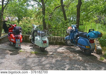 Villaggio Di Punta Sdobba, Italy - June 14 2020. Three Vespas, Part Of A Small Rally Of Vespa Motori