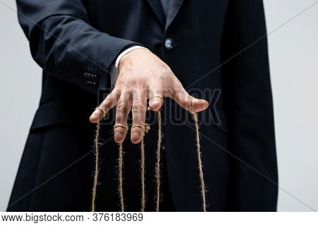 Partial View Of Puppeteer In Suit With Strings On Fingers Isolated On Grey