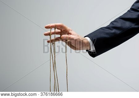 Cropped View Of Puppeteer With Strings On Fingers Isolated On Grey