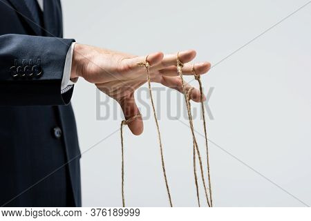 Cropped View Of Puppeteer With Strings On Fingers Isolated On Grey